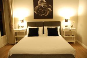 a bedroom with a large bed with two night stands at Maxim in Palermo