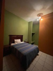 Postel nebo postele na pokoji v ubytování HOTEL PUEBLO GRANDE