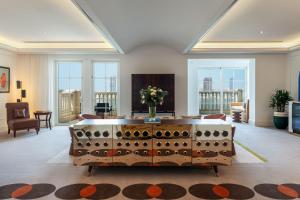 a living room with a table with a vase of flowers on it at The Westin Dubai Mina Seyahi Beach Resort and Waterpark in Dubai
