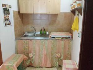a kitchen with a sink and a counter top at Casa Leone in Noto