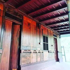 an empty room with wooden walls and a organ at Vattavada Jungle Resort in Munnar