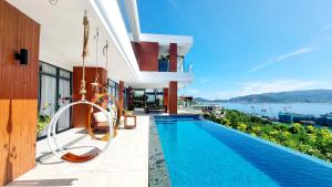 a villa with a swimming pool and a view of the ocean at Ocean Front Villa Nha Trang in Nha Trang