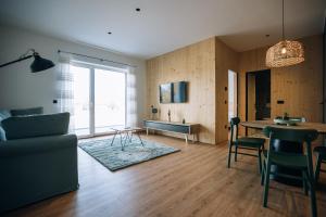 a living room with a couch and a table at Postcard Country Apartments in Spodnji Duplek