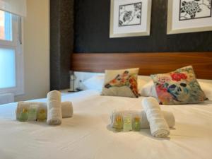 a pile of towels and squeeze bottles on a bed at ELCANO Bermeo 2 in Bermeo