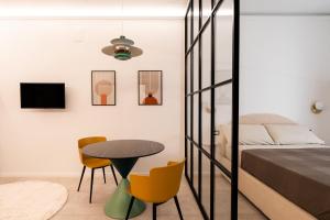 a bedroom with a table and chairs and a bed at Loft 404 by Wonderful Italy in Bari