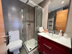 a bathroom with a shower and a toilet and a sink at ELCANO Bermeo 2 in Bermeo