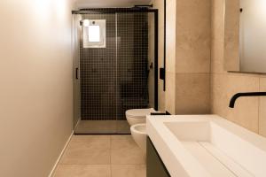 a bathroom with a toilet and a sink and a shower at Loft 404 by Wonderful Italy in Bari