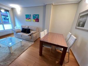 a living room with a table and a couch at Elcano Bermeo II in Bermeo