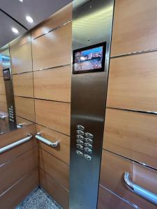 a bathroom with wooden walls and a television on the wall at ELCANO Bermeo 2 in Bermeo
