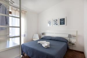 a bedroom with a blue bed and a window at Residence il Melograno in San Teodoro