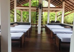 a row of beds in a room with ceilings at Forest Edge Bungalow - Wilpattu in Radagama