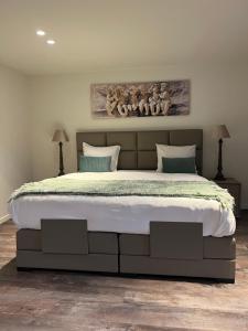 a bedroom with a large bed in a room at Elinoa in Machelen +25 photos