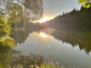 a body of water with a boat on it at Nature Center Údolí volavek in Weseritz