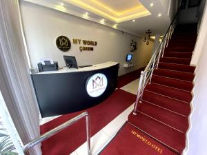 an office with a red carpeted stairs and a desk at MY WORLD OTEL ÇORUM in Corum