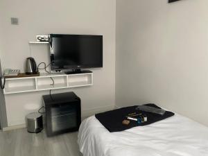 a room with a bed and a flat screen tv at MY WORLD OTEL ÇORUM in Corum