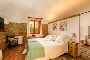 a bedroom with a large bed in a room at Mas Gran de Cruïlles - Mas Rural - Hotel & Events in Cruïlles