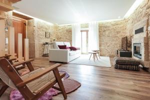 een woonkamer met een witte bank en een open haard bij RB Ganfei House in Valença
