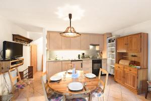 a kitchen with a wooden table and a dining room at Rustico Alla Bolla - Happy Rentals in Frasco