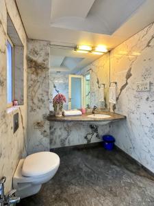 a bathroom with a toilet and a sink at Welcome Home Service Apartments - Andheri in Mumbai