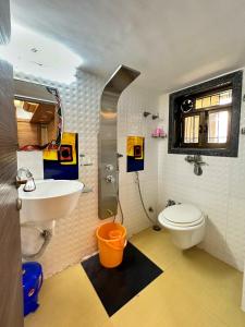 a bathroom with a white toilet and a sink at Welcome Home Service Apartments - Andheri in Mumbai