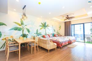 a bedroom with a bed and a table and a dining room at FLC Sea Tower - Căn Hộ Biển Quy Nhơn in Quy Nhon