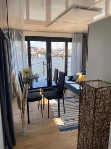 a living room with a table and a couch at Hausboot - Meeresbrise in Heiligenhafen +5 photos