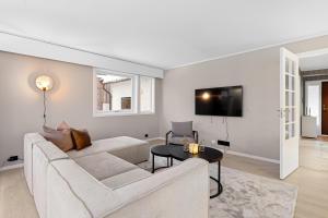 a living room with a couch and a table at Enter Tromsø - The Mountain View in Tromsø
