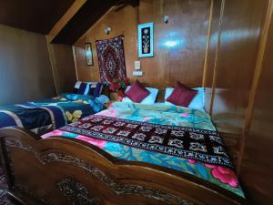 a bedroom with a bed and a couch at Houseboat New Suzan in Srinagar