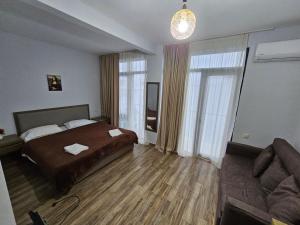 a hotel room with a bed and a couch at IVERIABEACH in Kobuleti +42 photos