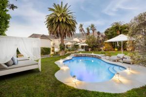 a swimming pool in the yard of a house at The Clarendon - Fresnaye in Cape Town