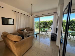 a living room with a couch and a chair at King's Holiday Apartments in Paphos
