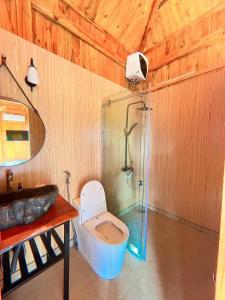 a bathroom with a tub and a toilet and a sink at ByVe Garden in Hanoi