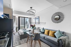a living room with a couch and a table at StoneTree - New Studio in JLT in Dubai
