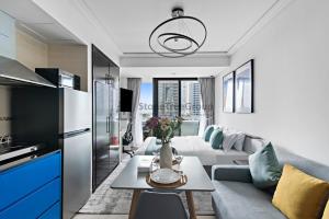 a living room with a couch and a table at StoneTree - New Studio in JLT in Dubai +4 photos