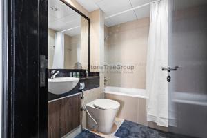 a bathroom with a toilet and a sink at StoneTree - New Studio in JLT in Dubai