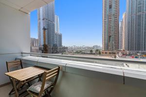 a balcony with a table and chairs and a view of a city at StoneTree - New Studio in JLT in Dubai