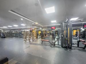 a gym with a lot of equipment in a room at StoneTree - New Studio in JLT in Dubai