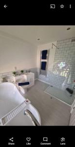 a white bathroom with a sink and a window at Peaceful Church Getaway in Middleton One Row