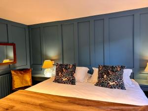 - une chambre avec un grand lit aux murs bleus dans l'établissement Octon Cottages Luxury 1 and 2 Bedroom cottages 1 mile from Taunton centre, à Taunton