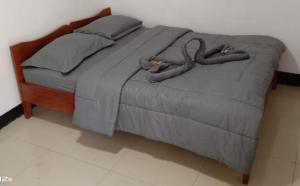 Una cama con dos serpientes en un dormitorio en BHELENA GUEST HOUSE, en Kelimutu