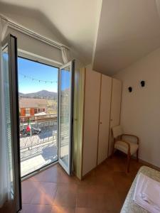 a bedroom with a sliding glass door to a balcony at Da Teresa in Bardineto