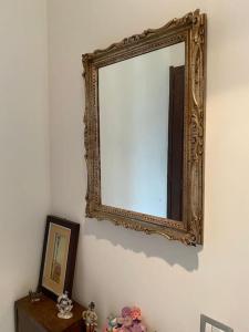 a mirror on a wall next to a table at Lella's Home in Quartu SantʼElena