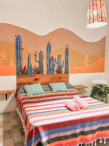 a bedroom with a bed with a cactus wall at Hostel Casa Maguey in Oaxaca City