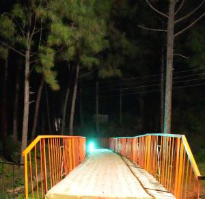 a bridge at night with a light on it at Pine Hideout in Kathua