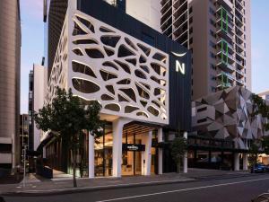 a building with a parametric facade on a city street at Novotel Perth Murray Street in Perth