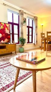 a living room with a table and a tv at Flat in Manchester, Ardwick in Manchester