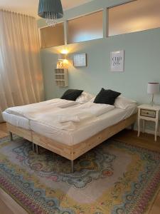 a large bed in a bedroom with a rug at Der Salon Hostel in Vienna