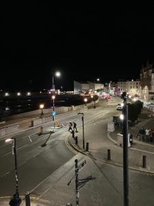 an empty city street at night with street lights at Imperial House "Serviced Apartments" in Margate