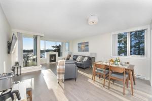 a living room with a table and a couch at Victoria West Harbourview in Victoria