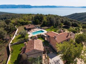 an aerial view of a house with a swimming pool at Villa Malini with Pool, Sauna and Fenced Garden in Labin